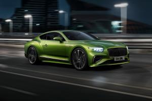 The new Hybrid Bentley Continental GT Speed in Tourmaline Green driving in an urban environment