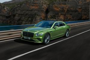 Front 3/4 The New Bentley Flying Spur Speed in Tourmaline Green driving on a bridge